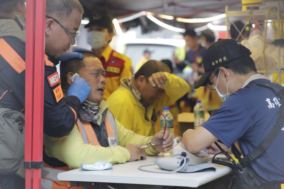 Two trapped workers of Taroko National Park have a physical examination after being rescued in Hualien County.