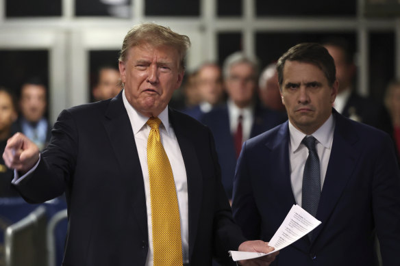 Donald Trump speaks to the media as his lawyer Todd Blanche watched on at Manhattan criminal court in New York on Wednesday (AEST).