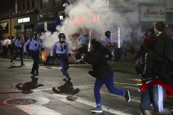 Police face off with protesters along 52nd Street in West Philadelphia in the early hours of Tuesday.