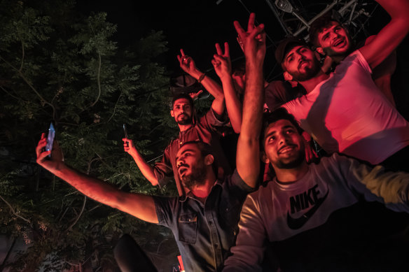 Palestinians celebrate the ceasefire agreement between Israel and Hamas on May 21, 2021 in Gaza City, Gaza. 