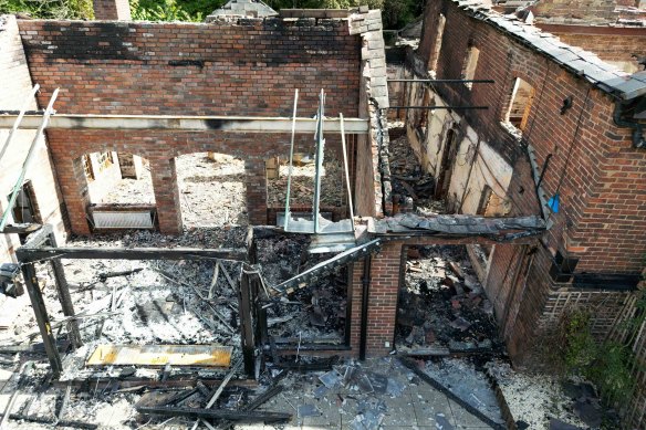 The burnt-out remains of The Crooked House pub near Dudley before its unauthorised demolition, which is now under investigation.