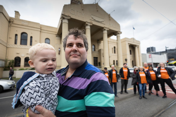 Yarra Residents Collective founder Adam Promnitz with two-year-old Xavier outside Richmond Town Hall.