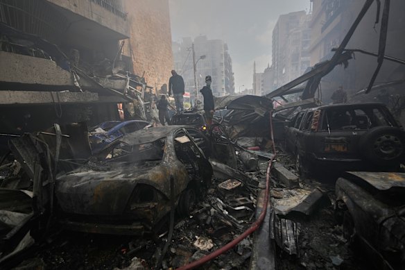 Residents look at the site of an Israeli airstrike in central Beirut.