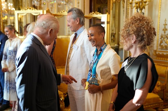 King Charles speaks with broadcaster and presenter Adele Roberts during a reception at Buckingham Palace on Wednesday.