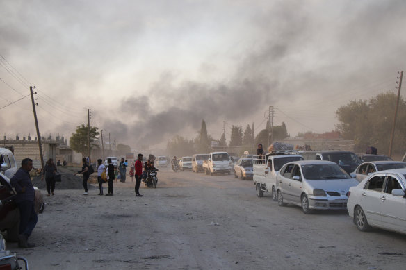 Syrians flee shelling by Turkish forces in Ras al Ain in north-east Syria before it fell to Turkish forces.
