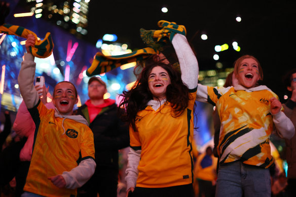 Fans in Melbourne celebrate after Steph Catley scores.
