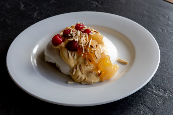 Pavlova with poached pears, raspberries, raspberries and lemon curd.