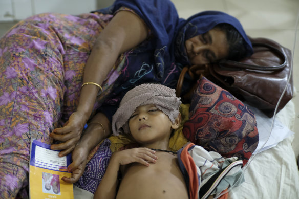 A child suffering from dengue receives treatment in hospital in Dhaka.
