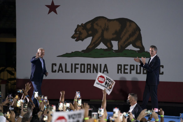 US President Joe Biden, left, waves to the crowd as he walks toward the podium to join California Governor Gavin Newsom at a rally on Monday ahead of the recall election.