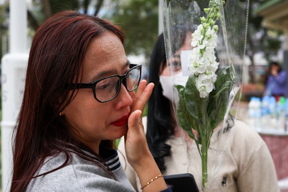 Indonesian domestic helper Alidia weeps as she mourns the passing of fire victims.