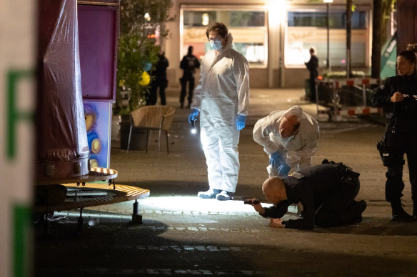 Forensic officers investigate the crime scene.