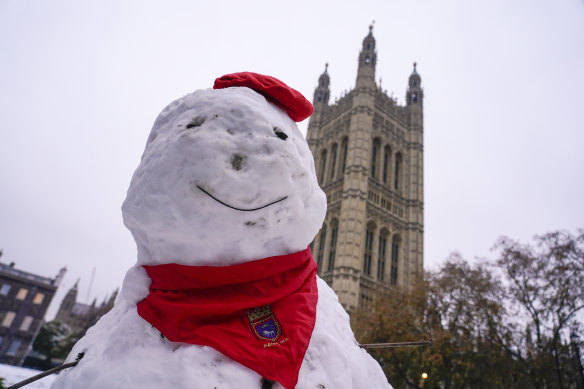 A snowman with the backdrop of the Victoria Tower in Westminster, in London, on Monday.