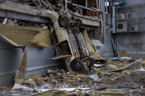 A vehicle stands upended in a former frontline neighborhood on May 21, 2022 in Kharkiv, Ukraine, where Russian forces have been targeting residential areas.