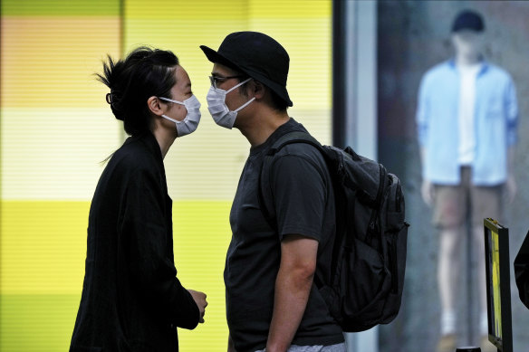 A Shanghai couple line up for COVID testing as the lockdown eases in the Chinese city.