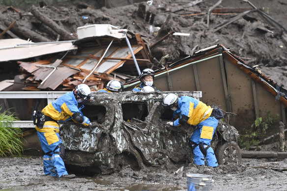 Rescuers conduct a search operation at the site of a mudslide at Izusan in Atami, Shizuoka prefecture, southwest of Tokyo on Sunday.