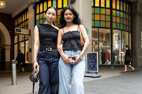 Sydneysiders Ronisha Bhandari and Priyanka Thandar with the colourful QVB windows as a backdrop.