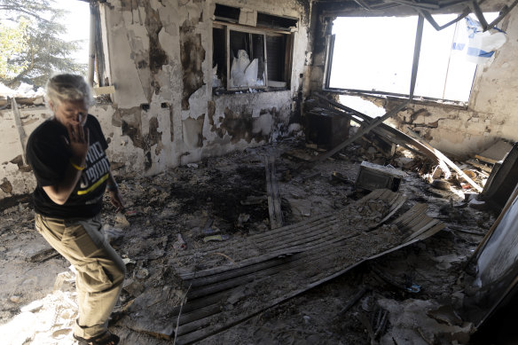 A kibbutz member returns to a destroyed house in Upper Galilee, Israel, near the Lebanese border, on Monday.