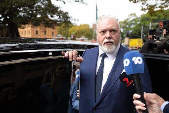 Kyle Sandilands was thronged by the media as he left court.