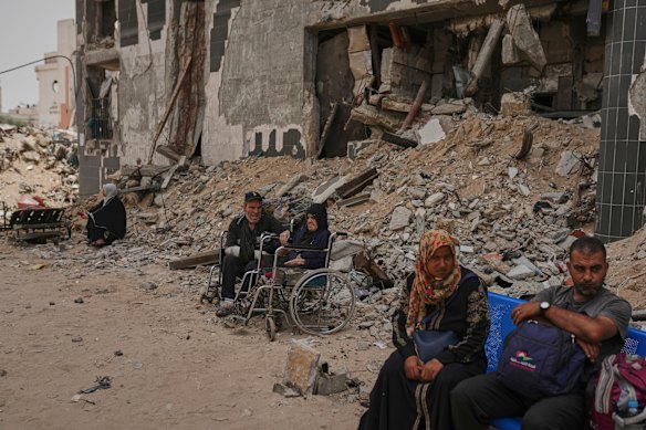 Kidney patients sit amid the destruction caused by an Israeli raid in Gaza City.