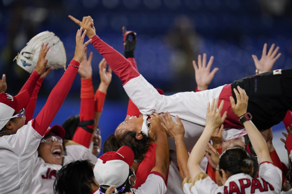 Japan’s softball team celebrates its gold medal win over USA.