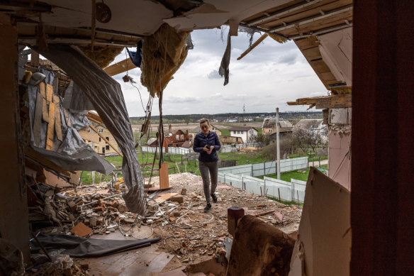 Local resident Oksana walks through the destroyed second floor of her multi-generational home while searching for salvageable items in Hostomel, Ukraine.