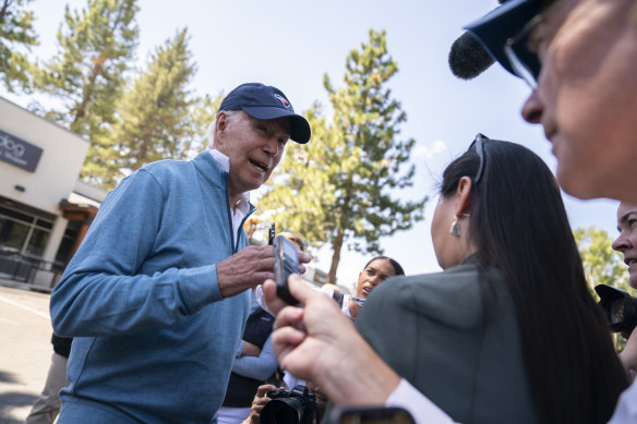 US President Joe Biden talks with reporters after taking a pilates and spin class in Lake Tahoe, California.
