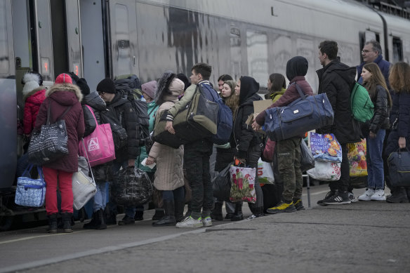 People board a Kyiv bound train on a platform in Kramatorsk, the Donetsk region, eastern Ukraine, Thursday, Feb. 24, 2022. 