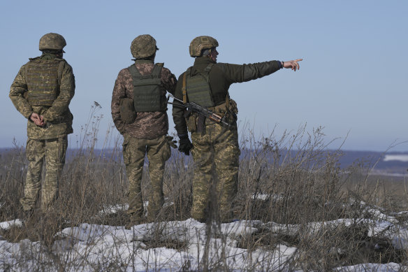 Ukrainian servicemen survey the impact of shells that landed close to their position in eastern Ukraine.
