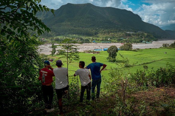 Locals in Devighat, Nepal view the Trishuli river from a hilltop after police warned of another possible surge.