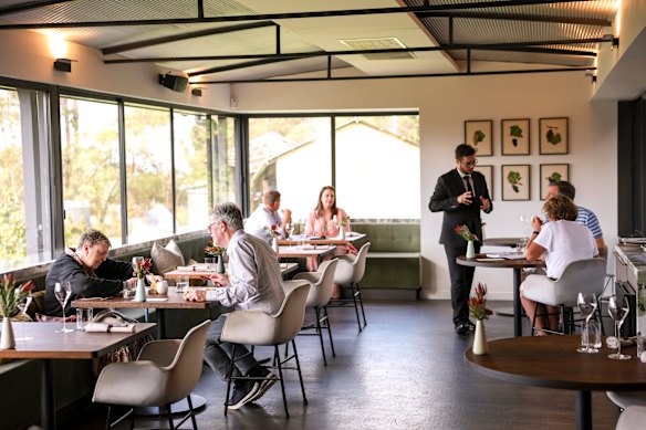 The plush dining room overlooks the vineyard.