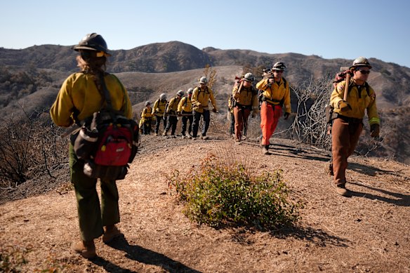 Fire crews work the burn zone of the Palisades Fire in Mandeville Canyon, Los Angeles, on Thursday.