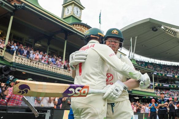 David Warner and Usman Khawaja head out to bat at the end of day one.