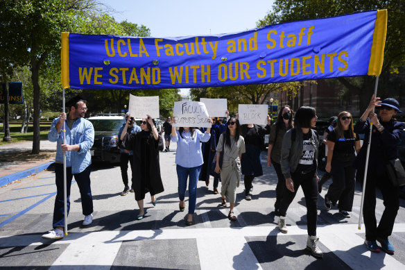 Faculty and staff march on the UCLA campus, after nighttime clashes between Pro-Israel and Pro-Palestinian groups. 