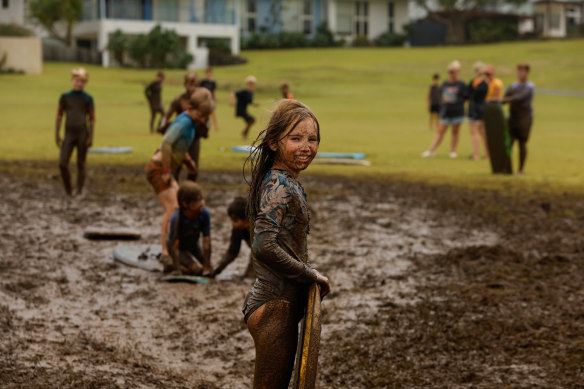 Lara Bowden, 10, playing in the mud in the wake of ex-Tropical Cyclone Alfred, at Skennars Head in northern NSW.