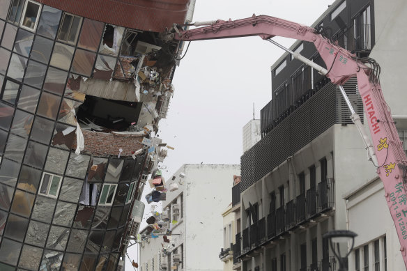 Heavy equipment begins demolition of a collapsed building in Hualien City on Friday.