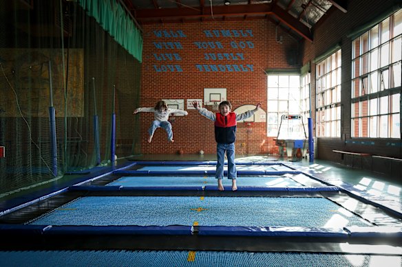 Jesse and Henrietta Longley bounce on the trampoline at the Don Bosco Youth Center sold by the Salesians. 
