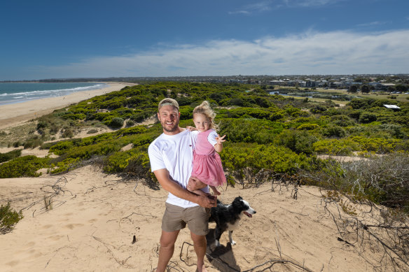 Paul Kenelley with daughter Romi and dog Kobe. They have moved into a new home in Torquay.