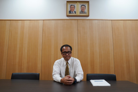 Kim Gui Dong, the school principal, in his office. Portraits of former North Korean dictators Kim Il-sung and Kim Jong-il are on the wall.