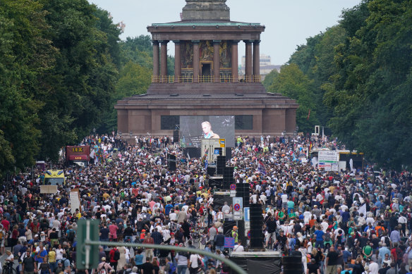 Protesters gather at the Victory Column in the Berlin to hear speeches during a protest against coronavirus-related restrictions.