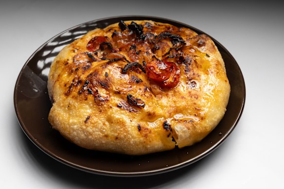 Ladenia flatbread with tomato and onion.