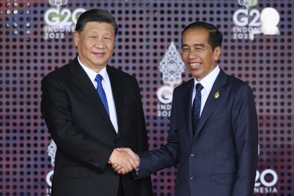 Chinese President Xi Jinping, left, is greeted by the Indonesian President Joko Widodo.