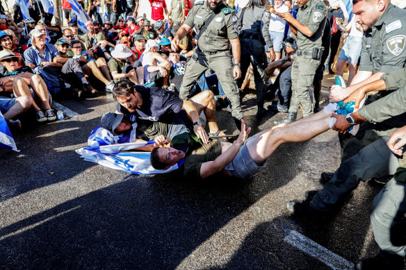 Israeli border police attempt to remove protesters from a road leading to the Knesset on Monday. 