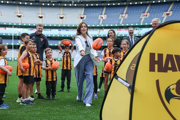 Queen Mary learns to handball a Sherrin on the MCG on Tuesday. 