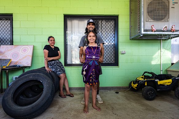 A local family from Hoppys Town camp in Alice Springs, Issaha Forbes (Western Arrente) with wife Louise and daughter Tahlaiyah, wearing a new dress to attend the NAIDOC cabaret.