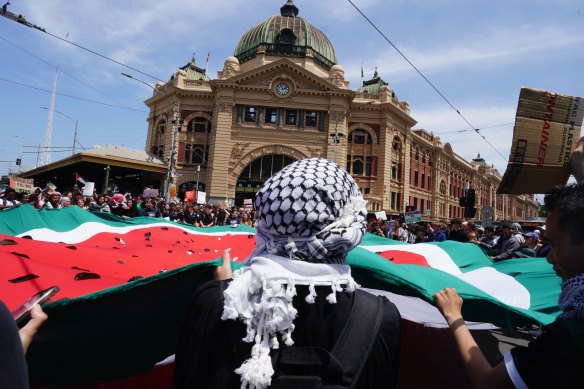 A protester in a keffiyeh at a pro-Palestinian student rally outside Melbourne’s Flinders Street Station.