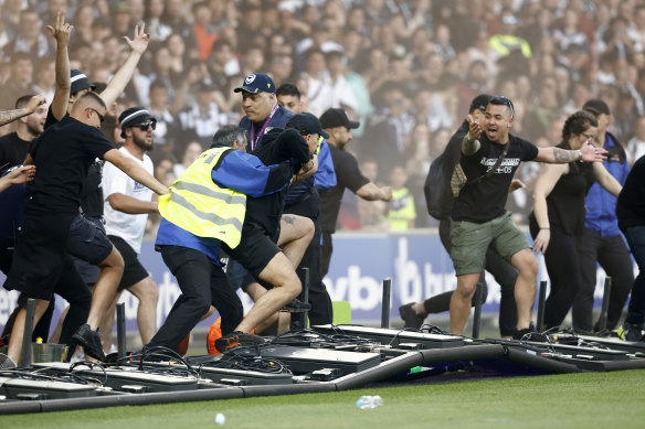Fans storm the field on Saturday night at AAMI Park.
