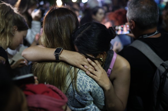 Fans console each other as they process the news. 