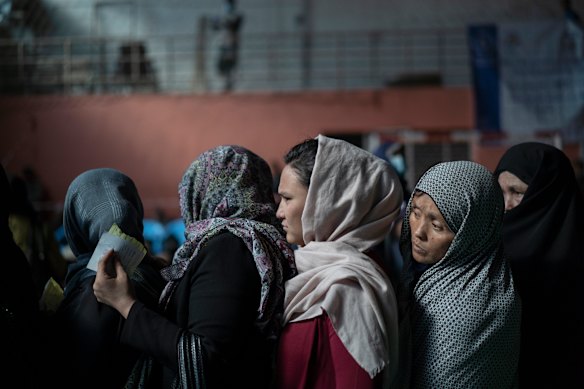 Women wait to receive cash at a money distribution organised by the World Food Program (WFP) in Kabul last week.