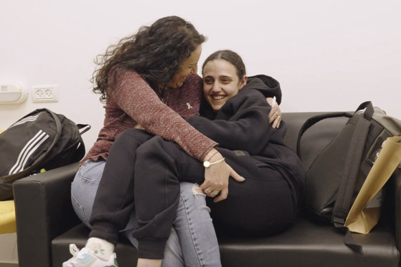 Romi Gonen, right, and her mother Merav hold each other near kibbutz Reim, southern Israel after Romi was released from captivity by Hamas militants in Gaza.