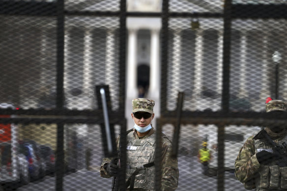 Members of the National Guard stand inside the security fencing at the Capitol ahead of the inauguration of President-elect Joe Biden and Vice President-elect Kamala Harris.